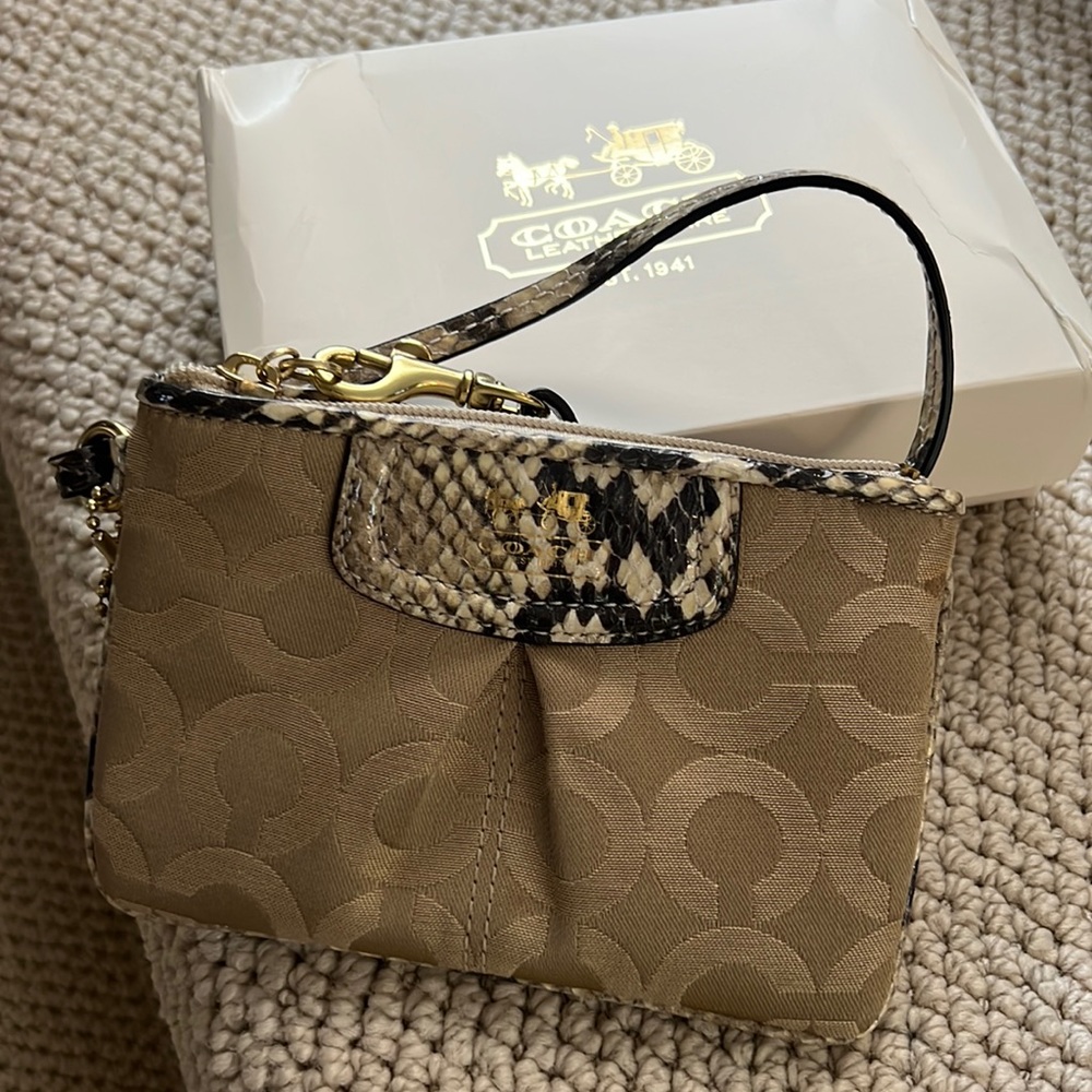 Coach wristlet with original box. Has signature "c" in fabric pattern.